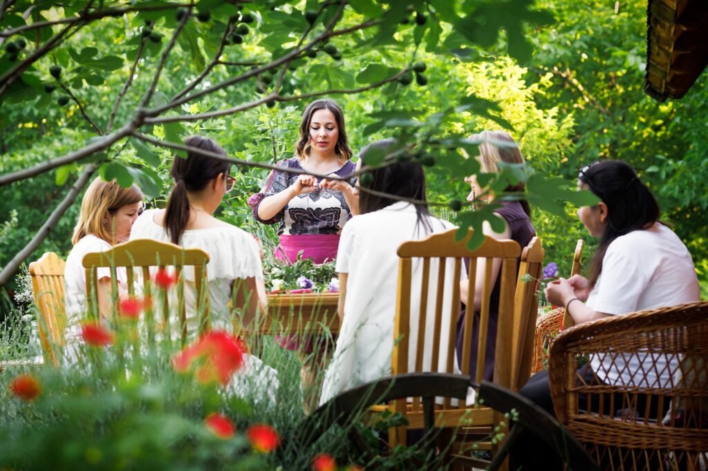 beautiful girl florist conducts a workshop on art in Serbian national village