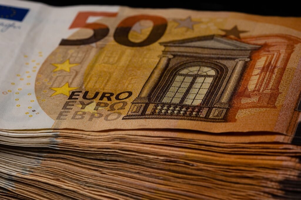 Closeup of the European Union Euro bill pile on a black background
